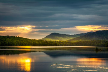 Loon watching the sunrise over Indian Lake Adirondacks New York - 281357886