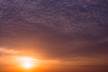 Dramatic dark sunset with bright sunshine and dark clouds.