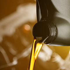 Pouring oil lubricant motor car from black bottle on engine background object transportation design
