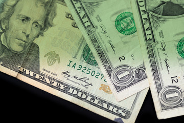 Dollar bills on dark background close up. Money background green color toned