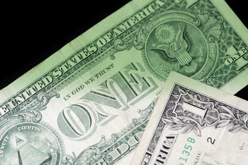 Dollar bills on dark background close up. Money background green color toned