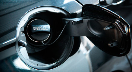 Diesel car concept. Open car fuel tank cap with the word diesel.