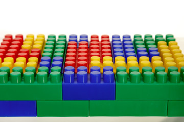 Children's colorful plastic construction toy bricks on white