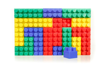 Children's colorful plastic construction toy bricks on white