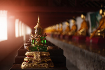 Fototapeta premium Buddha statue in thailand Temple with green emera