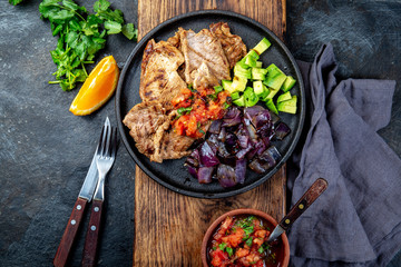 Yucatan Mexican Food Pork POC CHUC poc chuck. Pork marinaded in orange juice served with avocado, purple onion and rustic tomato sauce.