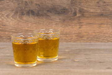 two glasses with homemade sweet wine on wooden table