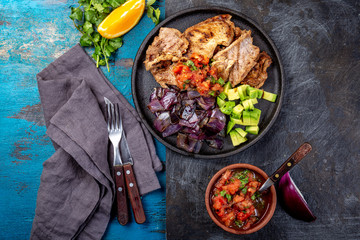 Yucatan Mexican Food Pork POC CHUC poc chuck. Pork marinaded in orange juice served with avocado, purple onion and rustic tomato sauce.
