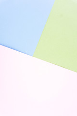 Flat layout of minimal colourful layer of pastel pink, green and blue orange paper background.