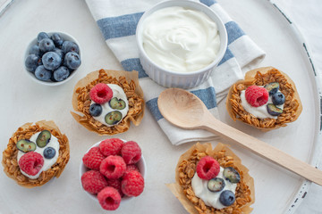 healthy home made granola cups with greek yogurt and berries on a table