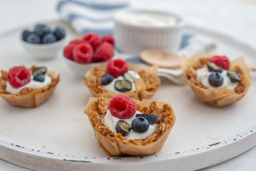healthy home made granola cups with greek yogurt and berries on a table