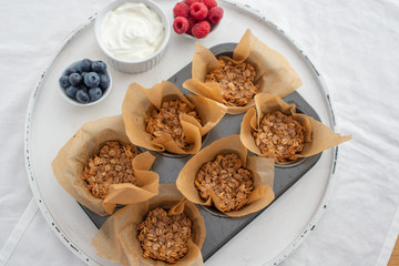healthy home made granola cups with greek yogurt and berries on a table