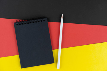 Blacklist Germany. Mourning, ban, sanctions, politics. black notebook and white pencil lies on...