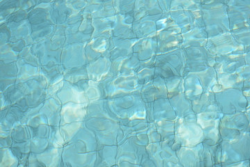 Water surface in a swimming pool. Blurred abstract background