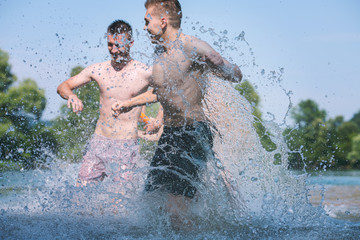 Fototapeta premium summer joy friends having fun on river