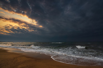 Fototapeta premium Dark stormy sea and empty beach