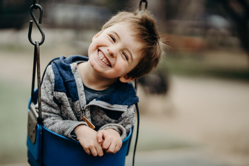 Portrait of a happy little boy at the playground