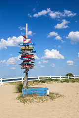 Signpost with destination mileage at Ocean View Beach in Norfolk, Virginia.