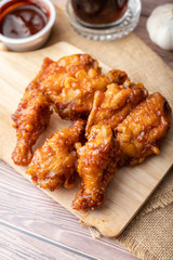 Hot and spicy Korean barbeque fried chicken on wood cutting board