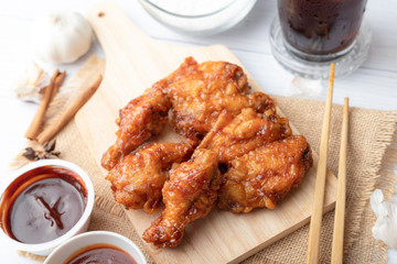 Hot and spicy Korean barbeque fried chicken on wood cutting board