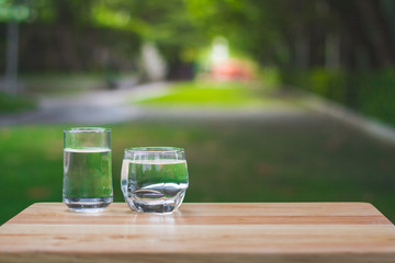 Drink water Purified  on table over sunlight and natural green background