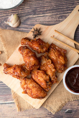 Hot and spicy Korean barbeque fried chicken on wood cutting board