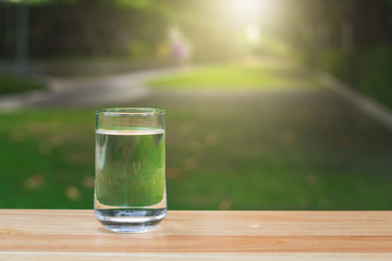 Drink water Purified  on table over sunlight and natural green background