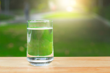 Drink water Purified  on table over sunlight and natural green background