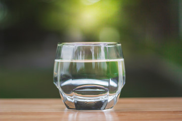 Drink water Purified  on table over sunlight and natural green background