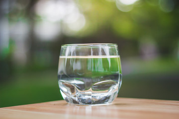 Drink water Purified  on table over sunlight and natural green background