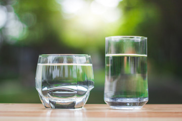 Drink water Purified  on table over sunlight and natural green background