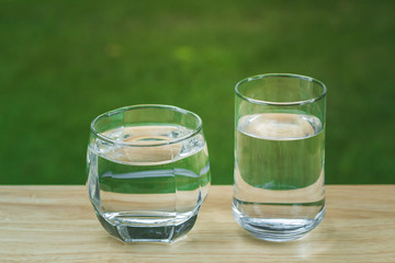 Drink water Purified  on table over sunlight and natural green background