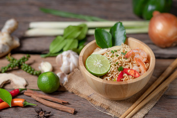 Close-up shot Instant noodles with lemon shrimp chilli hot and spicy on old wooden table select focus shallow depth of field