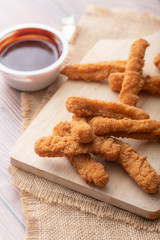 Hot and spicy Korean barbeque fried chicken on wood cutting board