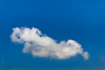 White fluffy clouds over a deep blue sky beautiful summer air background