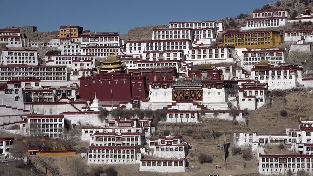 Overview of spectacular rebuilt Ganden monastery located in mountains near Lhasa, religion and tourism in Tibet
