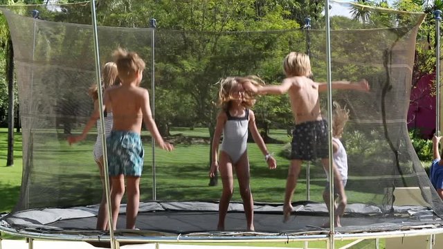 Kids inside trampoline jumping in slow-motion