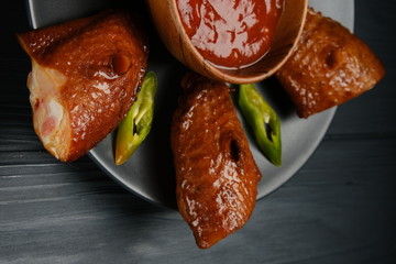smoked chicken wings on a gray plate, wood background