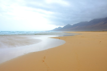 Long and Empty Fine Sand Beach of El Cofete in Fuerteventura on a Cloudy Day 