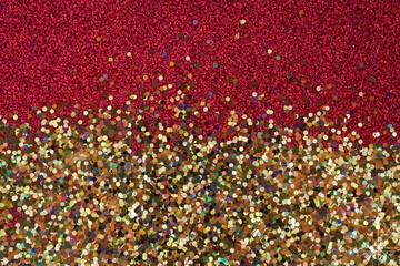 Glitter  background. Shiny red-gold background. New Year and Christmas background.Festive shiny...