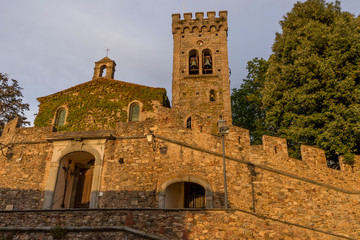 Fototapeta na wymiar The Church of San Lorenzo illuminated by the setting sun in the medieval village of Castagneto Carducci, Tuscany, Italy