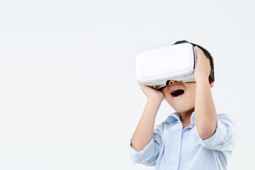 Asian boy playing game in vr glasses. Child touch something using modern virtual reality glasses