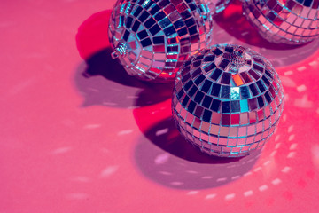 Mirror disco balls over pink background. Party, nightlife concept