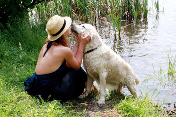 Woman Tenderly Hugging and Kissing Pet Dog.