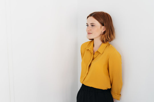 Young redhead woman standing thinking