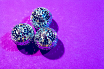disco ball shines on purple background close up