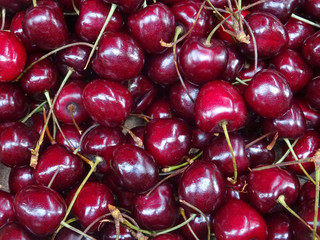  Delicious ripe sweet red cherries at the market as background, top view  closeup