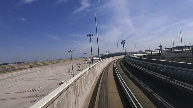 Backward Facing View of Riding the Skylink People Mover Terminal Train Tram at an Airport in Dallas
