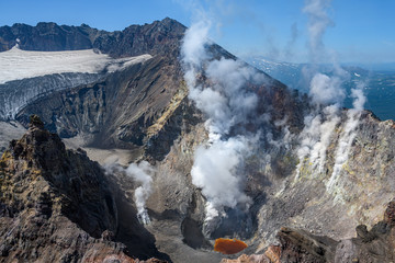 Panoramic view of the city Petropavlovsk-Kamchatsky and volcanoes: Koryaksky Volcano, Avacha Volcano, Kozelsky Volcano. Russian Far East, Kamchatka Peninsula.