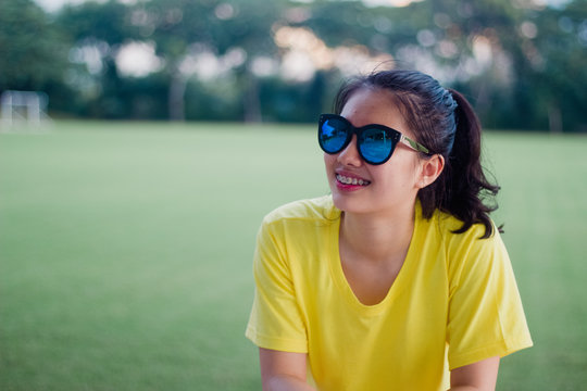 Lovely teen girl street style smiling with sunglasses under sunshine
